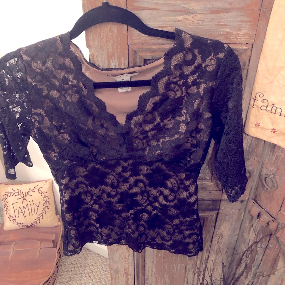 CABi brand sheer lace with flesh stone underlay.  Curbed v-neck style. Too cute!